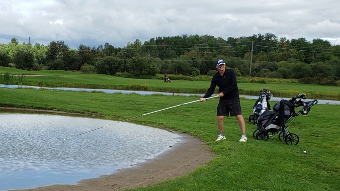 Blair Fishing Out a Golf Ball